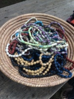 Elinora and her friends make these bracelets and necklaces out of seeds